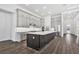 Spacious modern kitchen with gray cabinets, a large center island, and stainless steel appliances at 17719 Palmiste Dr, Bradenton, FL 34202