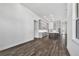 Open floorplan with an unfurnished living room leading to the kitchen and hardwood floors throughout at 17719 Palmiste Dr, Bradenton, FL 34202