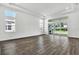 Bright living room with hardwood floors, many windows, and access to the outdoor living space at 17719 Palmiste Dr, Bradenton, FL 34202