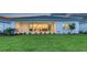Expansive backyard featuring lush green grass, manicured landscaping, and sliding glass doors for seamless indoor-outdoor living at 17811 Roost Pl, Bradenton, FL 34211