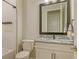 Elegant bathroom featuring a vanity, toilet, and a shower with white tiling at 17811 Roost Pl, Bradenton, FL 34211