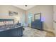 Well-lit blue-themed bedroom with a comfortable chair and a view from the window at 17811 Roost Pl, Bradenton, FL 34211