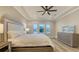 Spacious main bedroom with tray ceiling, large windows and a serene view at 17811 Roost Pl, Bradenton, FL 34211