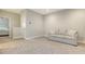 Upstairs bonus room area with a comfortable sofa and neutral carpet at 17811 Roost Pl, Bradenton, FL 34211
