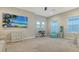 Large bonus room with a view of the water, featuring carpeted floors, a mounted TV and abundant natural light at 17811 Roost Pl, Bradenton, FL 34211