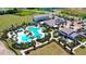 Stunning aerial view of a resort-style community pool with ample seating, lush landscaping, and inviting amenities at 17811 Roost Pl, Bradenton, FL 34211