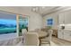 Cozy dining area with water view, modern lighting and access to the outdoor patio at 17811 Roost Pl, Bradenton, FL 34211