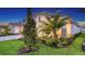 Charming home displaying well-maintained landscaping with green grass and elegant architectural details at 17811 Roost Pl, Bradenton, FL 34211