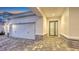 Front exterior of home with a two car garage and decorative stone accents at 17811 Roost Pl, Bradenton, FL 34211