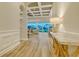 Bright hallway with a console table leading to an open living area with serene views of the backyard at 17811 Roost Pl, Bradenton, FL 34211