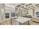 Modern eat-in kitchen featuring stainless appliances, granite counters, a large center island and open to living room at 17811 Roost Pl, Bradenton, FL 34211