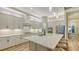 Bright kitchen featuring white cabinets, granite countertops, stainless steel appliances, and hardwood floors at 17811 Roost Pl, Bradenton, FL 34211