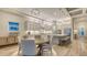 Modern kitchen and dining area featuring stainless appliances, granite counters, a center island and pendant lighting at 17811 Roost Pl, Bradenton, FL 34211