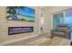 Chic living room with a modern fireplace and a comfortable seating area, showcasing an open layout at 17811 Roost Pl, Bradenton, FL 34211