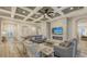 Bright, open-concept living room with coffered ceilings, decorative fireplace and sliding doors to outdoor patio at 17811 Roost Pl, Bradenton, FL 34211