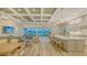 Bright, open-concept living space with a kitchen island and sliding doors with outdoor views at 17811 Roost Pl, Bradenton, FL 34211