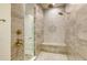 Modern shower featuring dual shower heads, built-in seating, and elegant tile work at 17811 Roost Pl, Bradenton, FL 34211