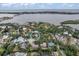 Aerial view of a waterfront home surrounded by lush greenery, with bay views and beautiful landscape at 1809 Buccaneer Ter, Sarasota, FL 34231
