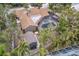 Aerial view of a home featuring a screened pool and lush landscaping at 1809 Buccaneer Ter, Sarasota, FL 34231