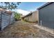 Spacious backyard with partial fence and view of house at 1809 Buccaneer Ter, Sarasota, FL 34231