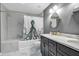 Stylish bathroom featuring double sinks and a tub with a unique shower curtain at 1809 Buccaneer Ter, Sarasota, FL 34231