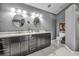 Modern bathroom with double vanity, elegant lighting, sleek cabinets, and a separate toilet and shower area at 1809 Buccaneer Ter, Sarasota, FL 34231