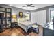 Cozy bedroom featuring a ceiling fan, and wood flooring, providing a relaxing ambiance at 1809 Buccaneer Ter, Sarasota, FL 34231