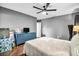 Bedroom boasts a ceiling fan, blue dresser, neutral decor, providing modern comfort at 1809 Buccaneer Ter, Sarasota, FL 34231