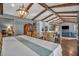 Open floor plan showcasing dining area, island kitchen and comfortable living room with vaulted ceilings and wooden beams at 1809 Buccaneer Ter, Sarasota, FL 34231