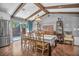 Dining area with access to the pool boasts modern lighting, wood flooring, and neutral decor for a stylish dining experience at 1809 Buccaneer Ter, Sarasota, FL 34231
