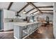Open kitchen and dining area features exposed beam ceiling and modern appliances at 1809 Buccaneer Ter, Sarasota, FL 34231