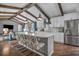 Bright kitchen boasts white cabinets, stainless steel appliances, island with bar seating, and wood beam details at 1809 Buccaneer Ter, Sarasota, FL 34231
