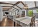 Open concept kitchen with wooden beams, an island with barstool seating, and stainless steel appliances at 1809 Buccaneer Ter, Sarasota, FL 34231