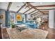 Inviting living room with a large sectional sofa, area rug, and wood-beamed ceiling creating a cozy atmosphere at 1809 Buccaneer Ter, Sarasota, FL 34231