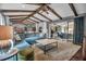 Open-concept living area showcasing seamless flow to dining and kitchen spaces and vaulted ceilings with wooden beams at 1809 Buccaneer Ter, Sarasota, FL 34231