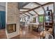 Inviting open-concept living area with a stone fireplace, wooden beams, and kitchen views at 1809 Buccaneer Ter, Sarasota, FL 34231