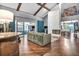 Bright living room featuring vaulted ceilings, wood beams, a brick fireplace, and access to the outdoor living space at 1809 Buccaneer Ter, Sarasota, FL 34231