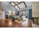Spacious living room with vaulted ceilings, wood floors, a fireplace, and access to the backyard and pool area at 1809 Buccaneer Ter, Sarasota, FL 34231