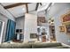 Open-concept living area with fireplace, wood floors, high ceilings, and access to dining room and other rooms at 1809 Buccaneer Ter, Sarasota, FL 34231