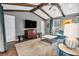 Cozy living space features wood-beamed vaulted ceilings and a large window, offering natural light and charm at 1809 Buccaneer Ter, Sarasota, FL 34231