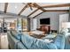 Comfortable living area with sliding glass doors to the pool area and vaulted ceilings with wooden beams at 1809 Buccaneer Ter, Sarasota, FL 34231