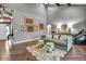 Spacious living room featuring wood floors, high ceilings, ample artwork, stylish furnishings, and an open layout at 1809 Buccaneer Ter, Sarasota, FL 34231