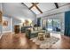 Open living room area with wood floors, a vaulted ceiling, a sofa with patterned pillows, and access to the backyard at 1809 Buccaneer Ter, Sarasota, FL 34231