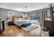 Relaxing main bedroom with wood floors, sliding glass doors to the pool area, and neutral-toned furnishings at 1809 Buccaneer Ter, Sarasota, FL 34231