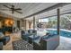 Covered patio with comfortable seating overlooking a sparkling pool surrounded by lush landscaping at 1809 Buccaneer Ter, Sarasota, FL 34231