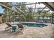 Beautiful screened pool area with lounge seating and tropical landscaping at 1809 Buccaneer Ter, Sarasota, FL 34231