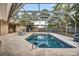 Screened-in pool with easy access and tiled surroundings at 1809 Buccaneer Ter, Sarasota, FL 34231