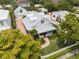 Beautiful two-story home with a metal roof, lush landscaping, brick driveway, and a detached garage at 1841 Datura St, Sarasota, FL 34239