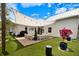 Inviting backyard features an outdoor TV, grill, and comfortable seating area under a modern shade sail at 1841 Datura St, Sarasota, FL 34239