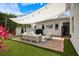 Landscaped backyard with a patio, comfortable seating area, grill, and artificial grass at 1841 Datura St, Sarasota, FL 34239